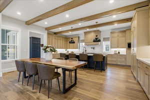 Dining space featuring light wood finished floors, beam ceiling, and recessed lighting