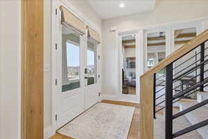 Entrance foyer with light wood flooring and recessed lighting