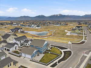 Aerial perspective of suburban area featuring a Daybreak Watercourse and mountain view
