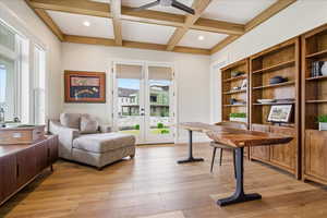 Office space featuring french doors, light wood  floors, coffered ceiling, ceiling fan, and recessed lighting, french doors to covered porch, walk in closet