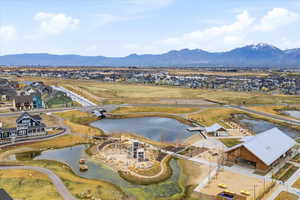 Aerial perspective of suburban area featuring a Daybreak watercourse and walking paths and mountain view