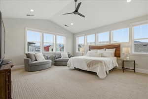 Primary Bedroom with recessed lighting, light colored carpet, and a ceiling fan, electronic roller shades