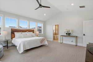 Primary Bedroom featuring recessed lighting, lofted ceiling, light carpet, ensuite bath, and ceiling fan