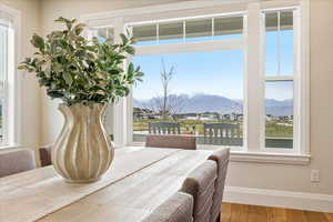 Dining Room featuring multiple windows, wood finished floors, and a mountain view