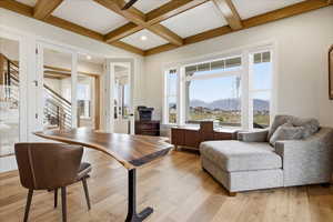 Home office featuring coffered ceiling, a mountain view, light wood flooring, and recessed lighting, glass french doors, walk in closet