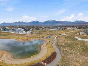 View of mountain background with nearby suburban area and a nearby body of Daybreak Watercourse