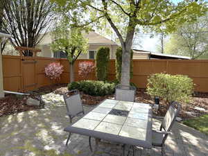 Fenced backyard with a patio and outdoor dining area