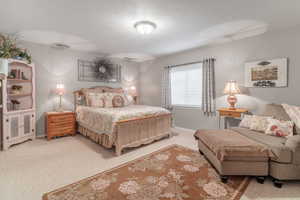 Carpeted bedroom featuring baseboards