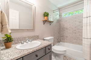 Full bathroom featuring vanity and shower / bathtub combination with curtain