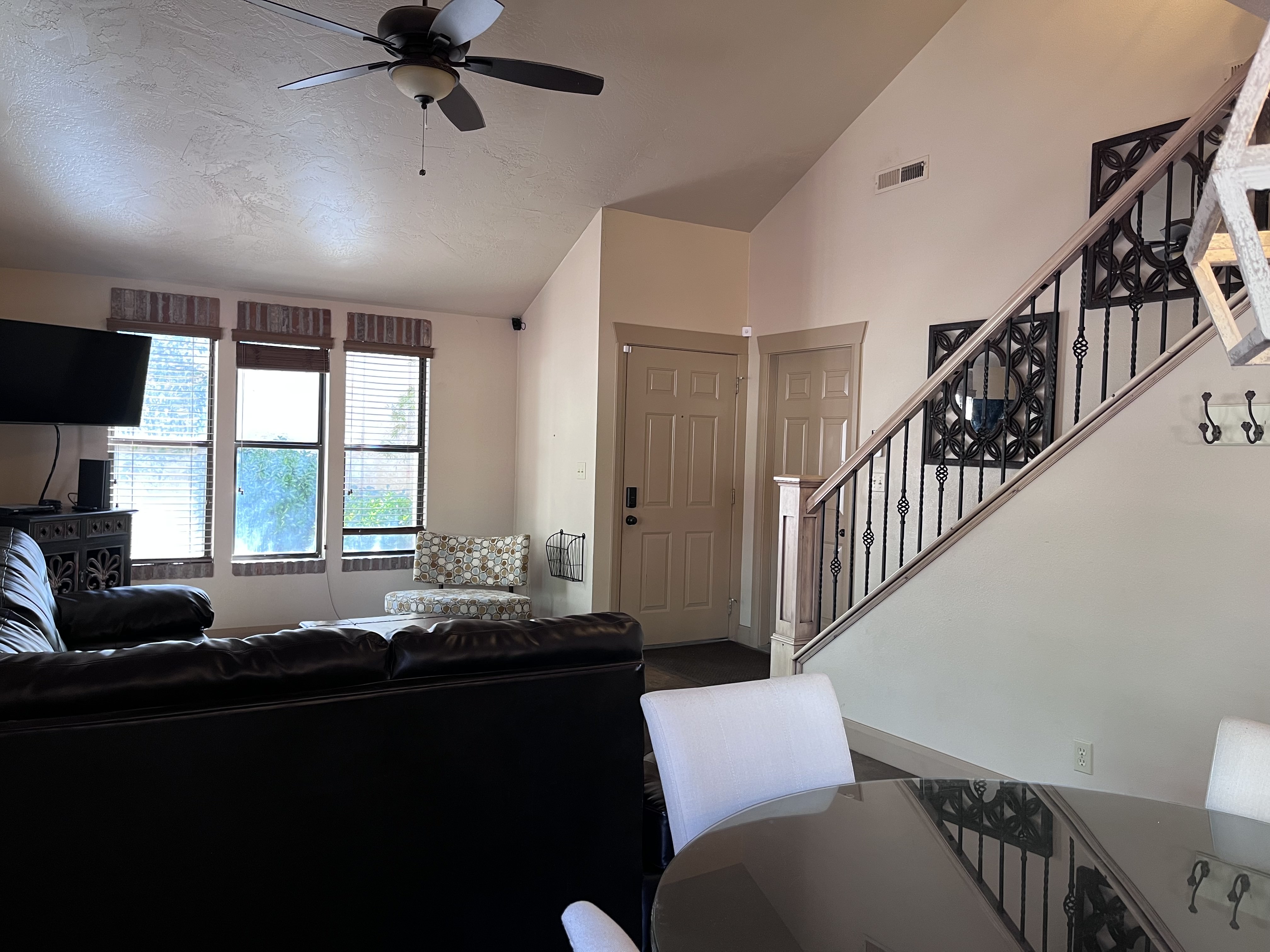 Living area with a ceiling fan and lofted ceiling