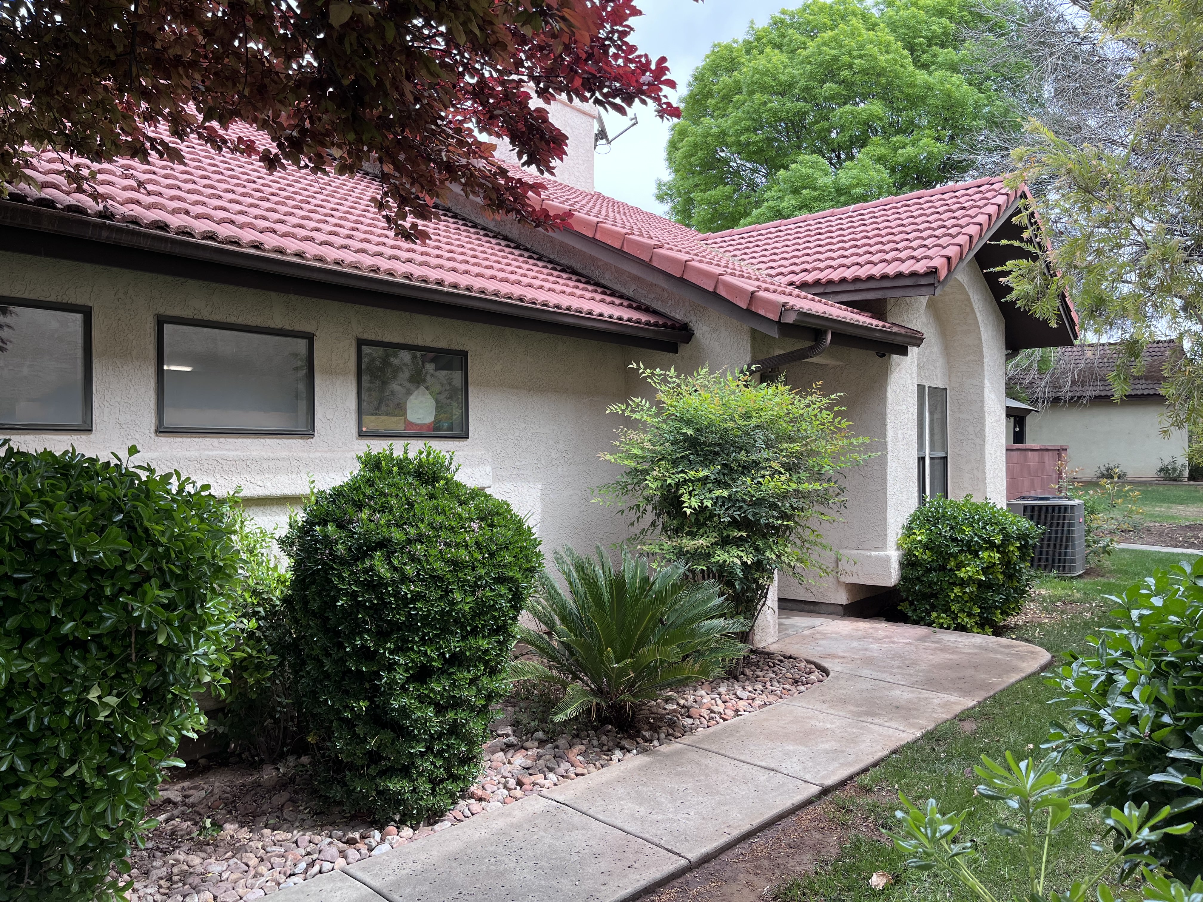 View of side of home featuring stucco siding and a tile roof