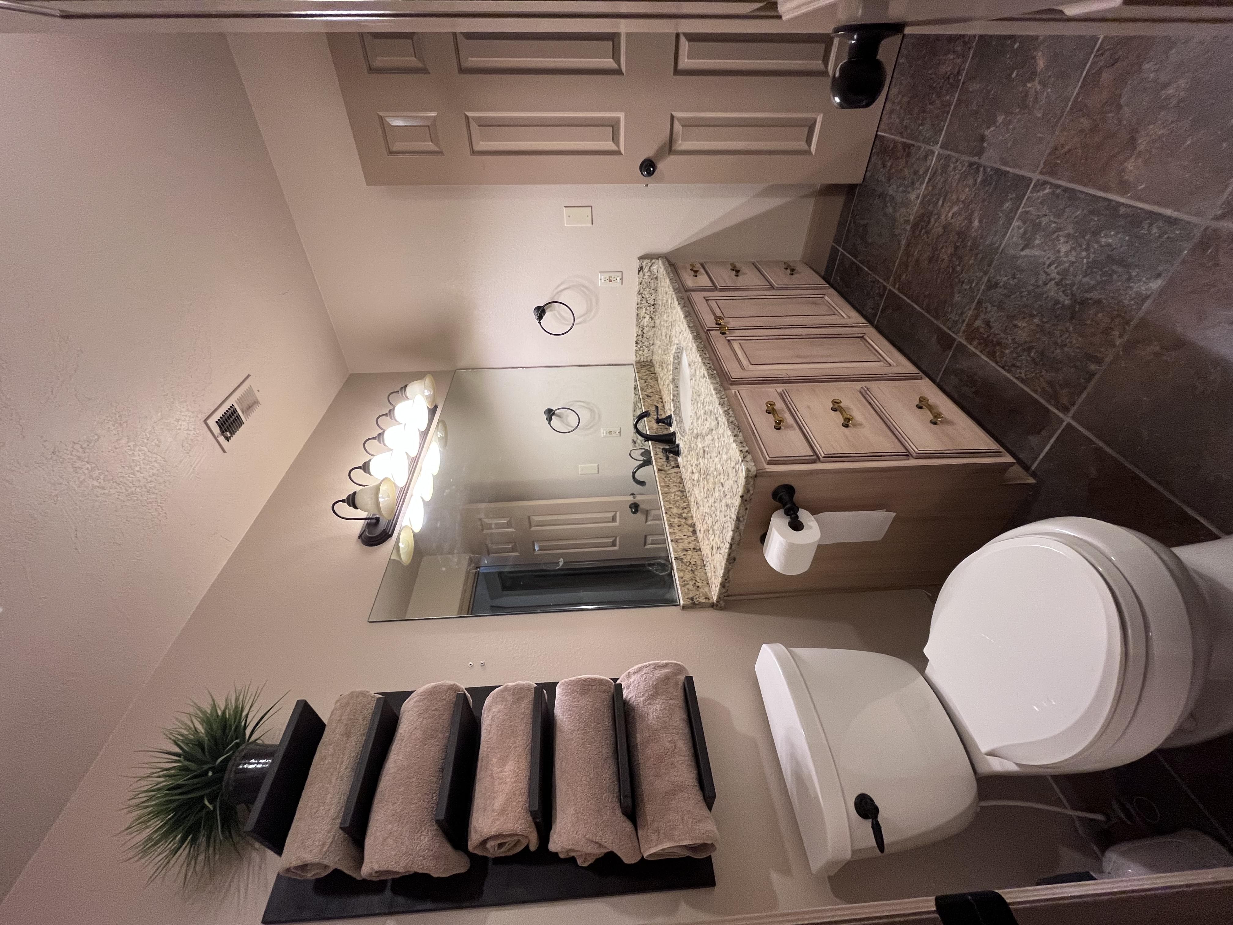 Half bath with vanity and a textured ceiling