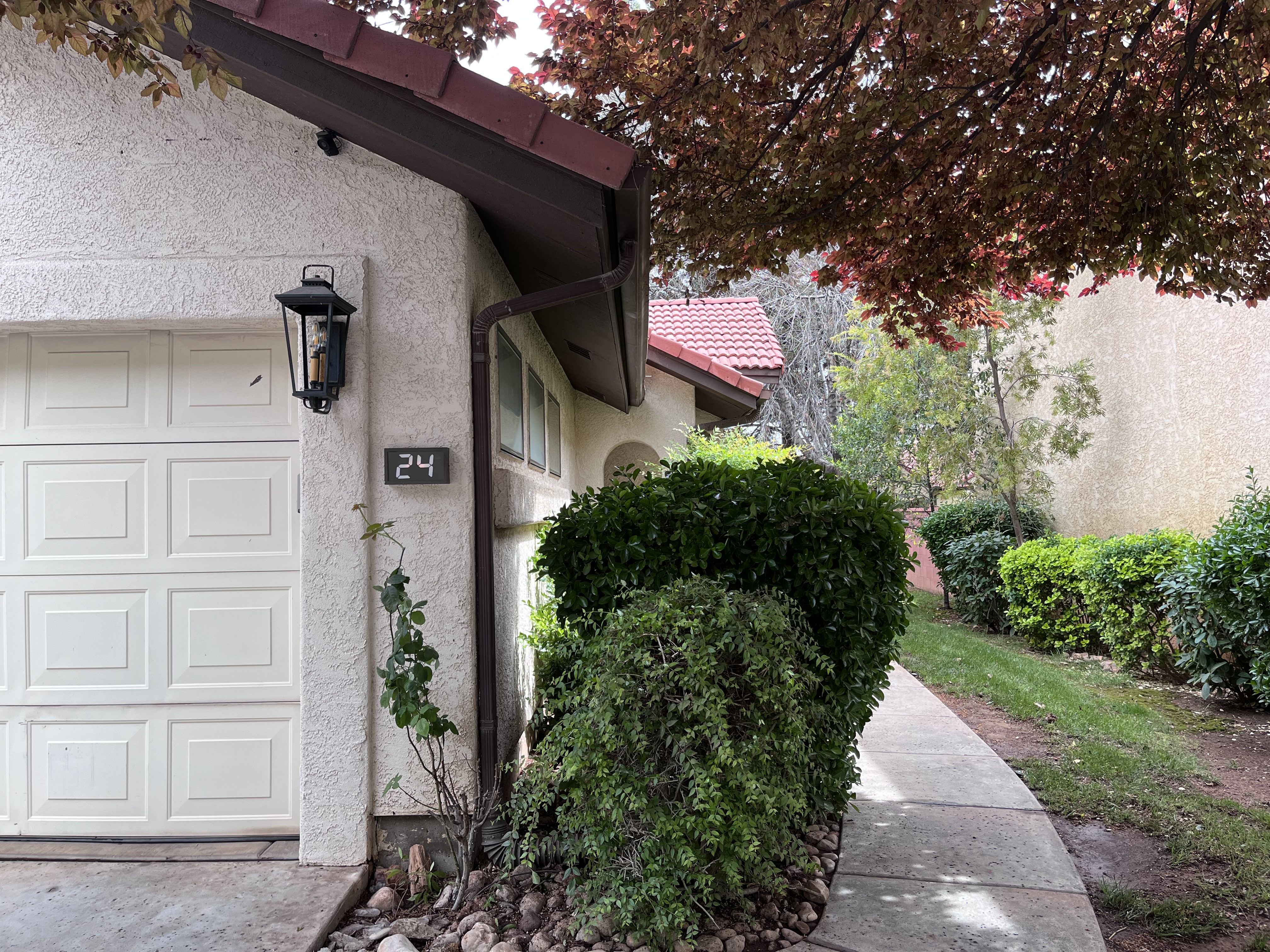 Entrance to property with stucco siding and a garage
