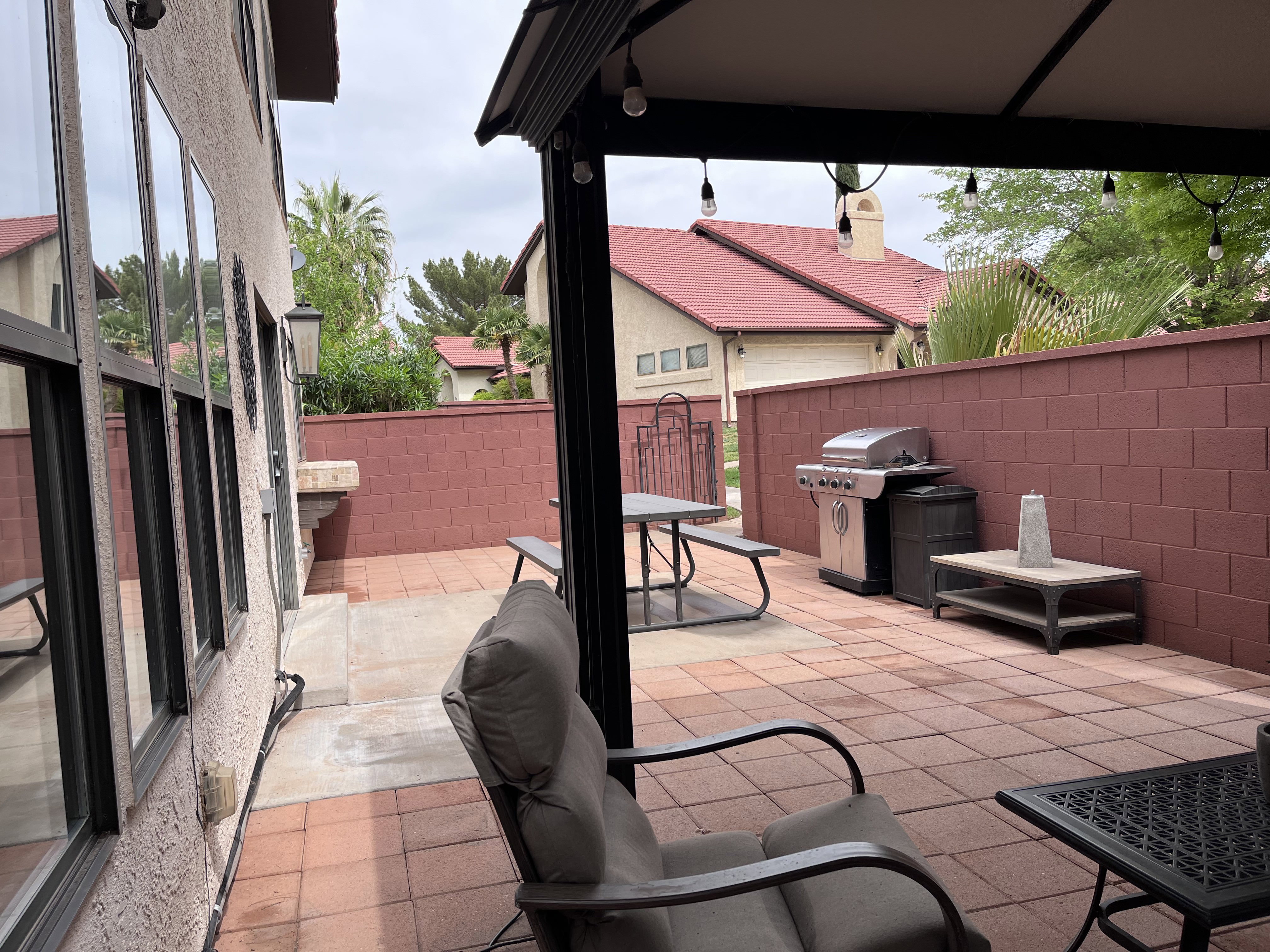Fenced backyard featuring a patio, area for grilling, and outdoor dining area