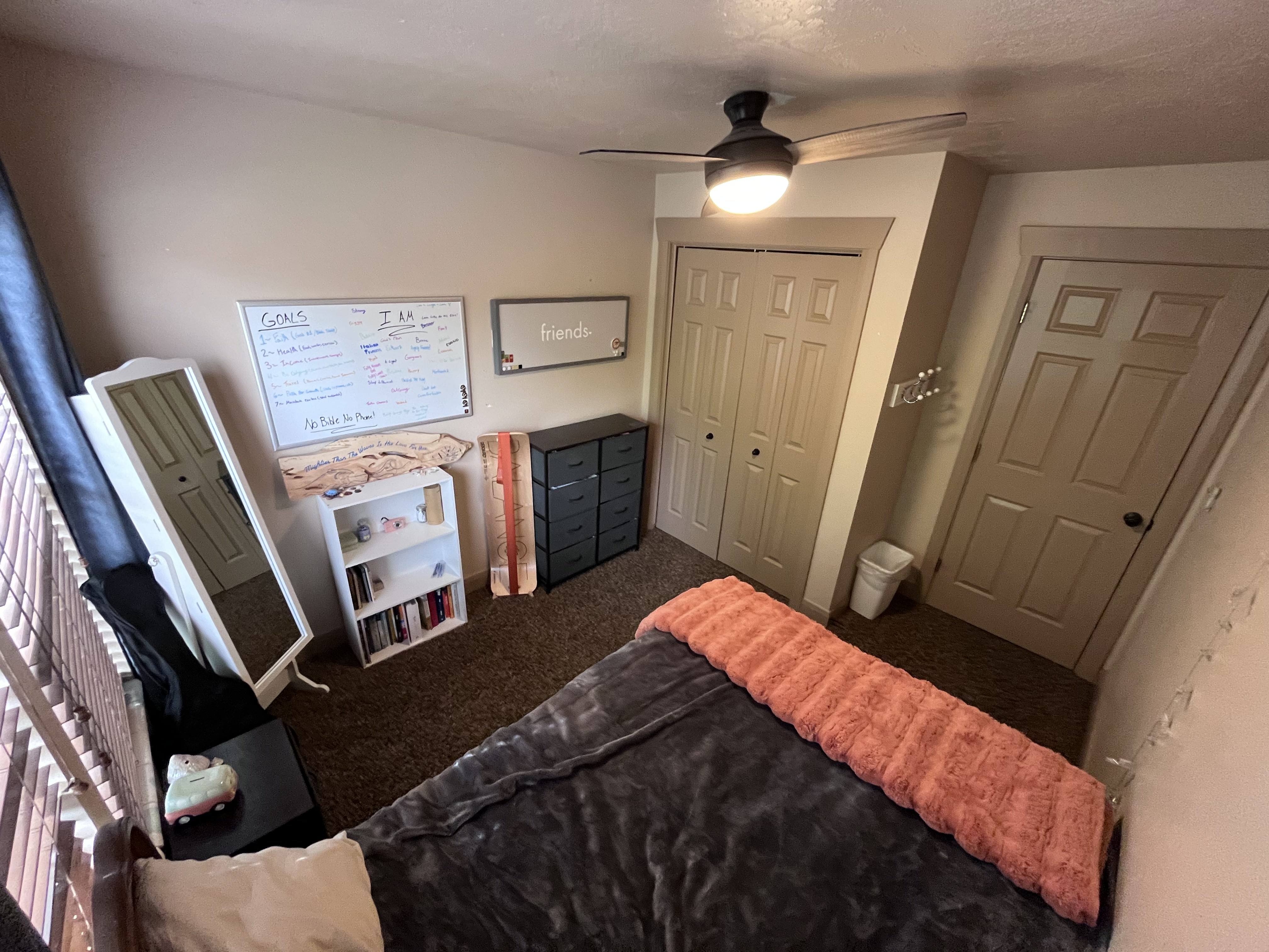 Carpeted bedroom with a closet and a ceiling fan