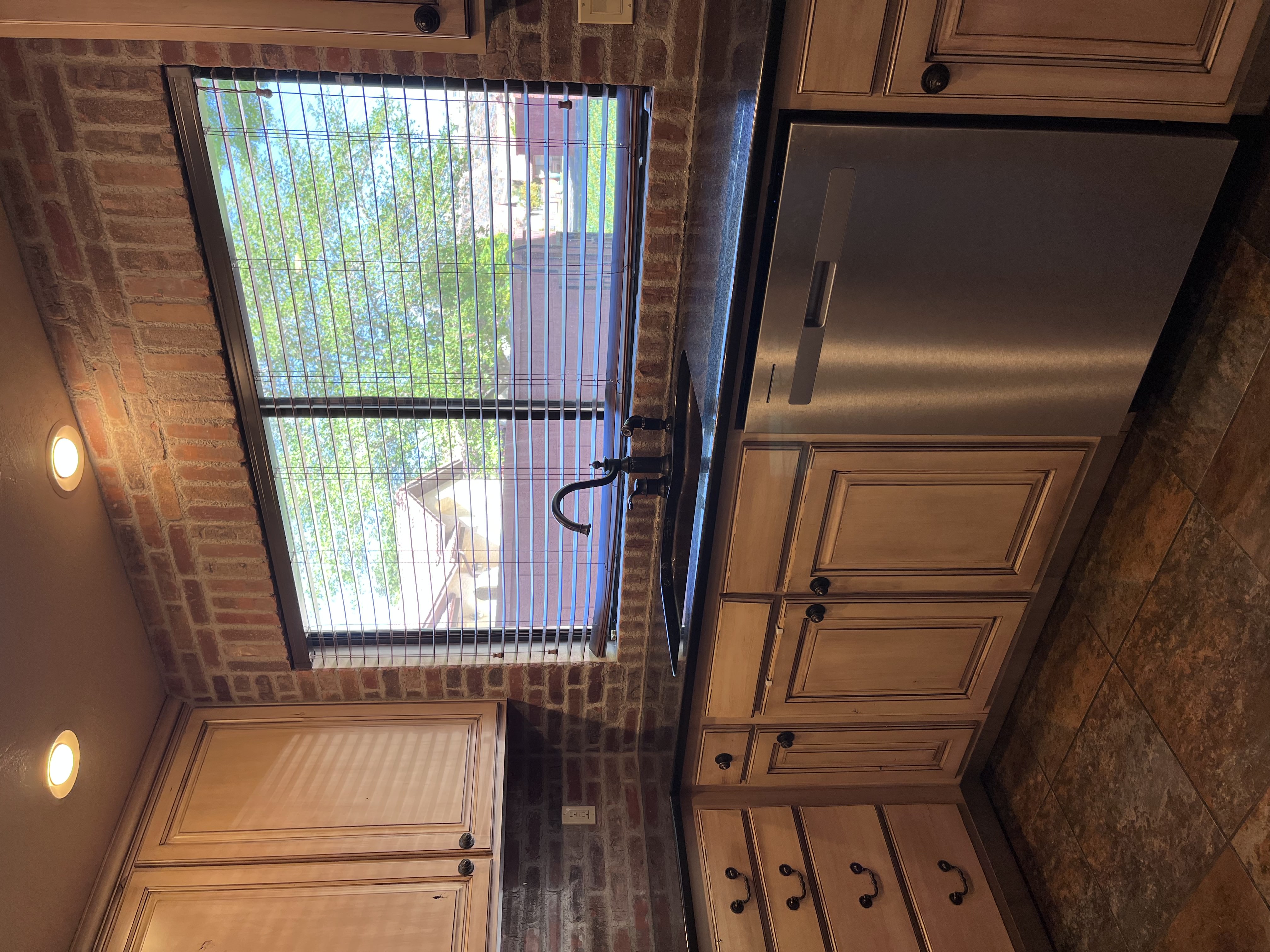Kitchen featuring dishwasher, dark countertops, and recessed lighting