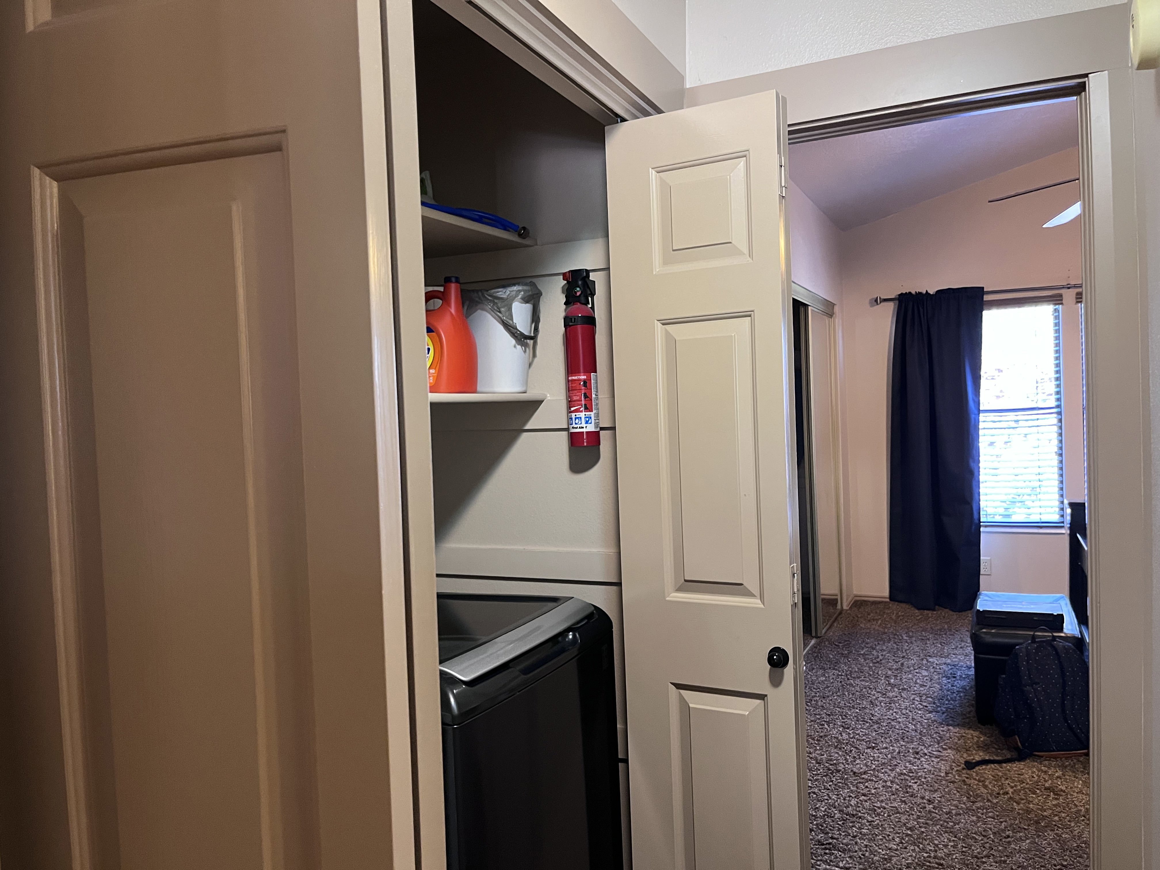 Laundry area featuring vaulted ceiling, washer / dryer, and carpet floors