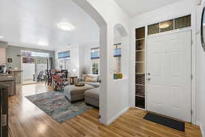 Foyer with light wood-style flooring and plenty of natural light