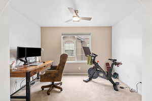 Office space featuring light colored carpet and ceiling fan