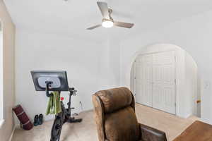Office area featuring carpet floors and a ceiling fan