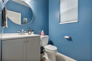 Half bathroom with vanity and light tile patterned floors