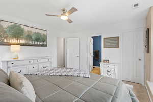 Bedroom with ceiling fan and light carpet