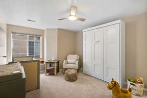 Sitting room with light carpet and ceiling fan