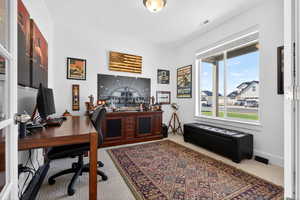 Office area with light carpet and glass french doors