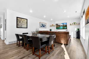 Dining room featuring light wood-style flooring and recessed lighting
