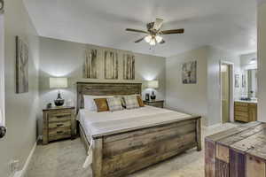 Bedroom with connected bathroom, brand new carpet, and a ceiling fan