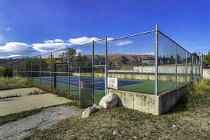 View of tennis court and pickle ball court featuring community basketball court and a mountain view