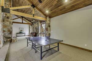 Recreation room with light carpet and high vaulted wood ceiling