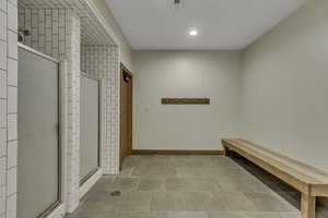 Mudroom featuring recessed lighting and showers
