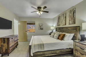 Bedroom featuring ceiling fan, brand new carpet, and a baseboard radiator
