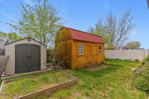 View of shed with a garden and a fenced backyard