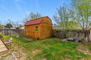 View of shed featuring a fenced backyard