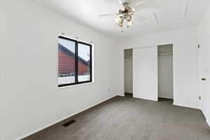 Unfurnished bedroom featuring carpet floors, a closet, and a ceiling fan