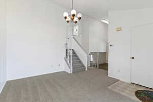 Unfurnished dining area with carpet flooring and suspended lighting
