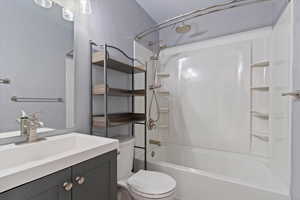 Bathroom with vanity and shower / tub combination