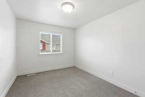 Empty room with baseboards and light carpet