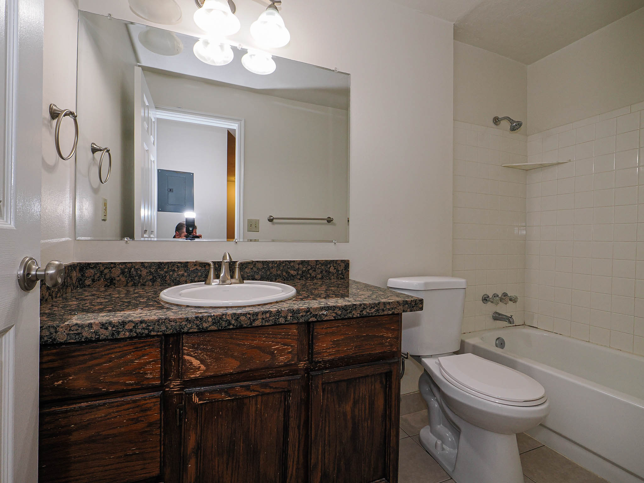 Full bathroom featuring vanity, light tile patterned floors, and shower / washtub combination