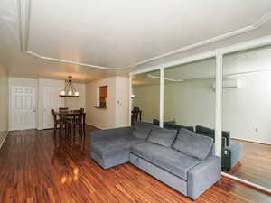 Living area with dark wood finished floors and a wall mounted mini split