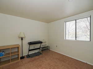 Spare room with parquet flooring and baseboards