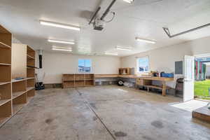 Garage with electric panel and a garage door opener