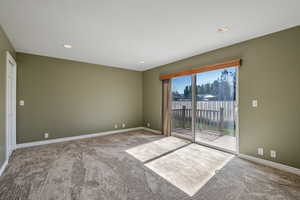 Empty room with carpet flooring and recessed lighting
