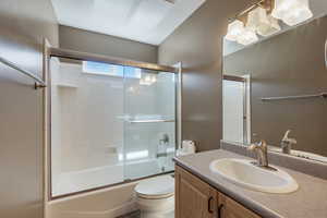 Full bath with vanity and shower / bath combination with glass door