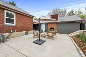 View of patio with a warm lit fireplace