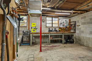Basement featuring a workshop area and a heating unit