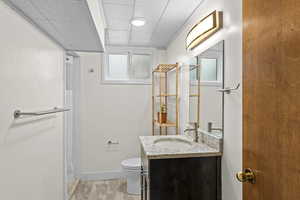 Full bathroom with vanity, a paneled ceiling, and light wood finished floors