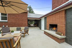View of patio / terrace with an outdoor brick fireplace